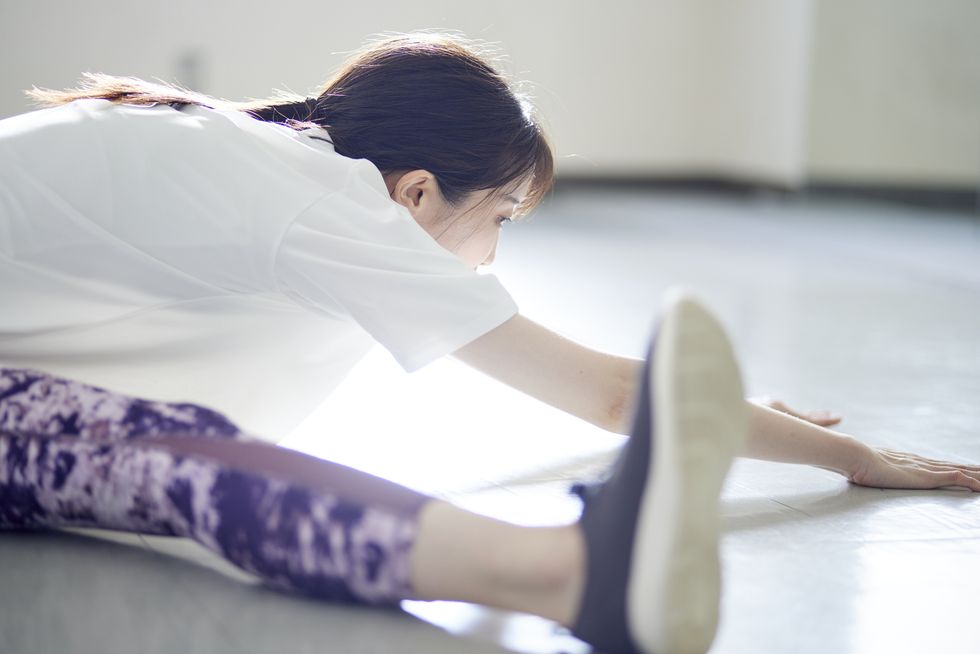 young japanese woman doing stretching