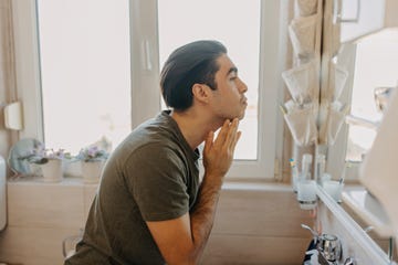 young latin man taking good care of himself in the morning