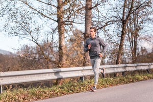 young male athlete running in the nature