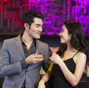 young man and woman flirting at bar