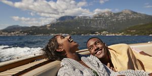 young man and woman laughing in speedboat