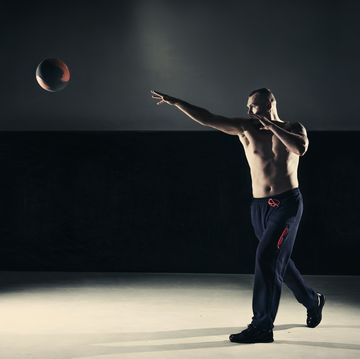 young man cross training with a medicine ball