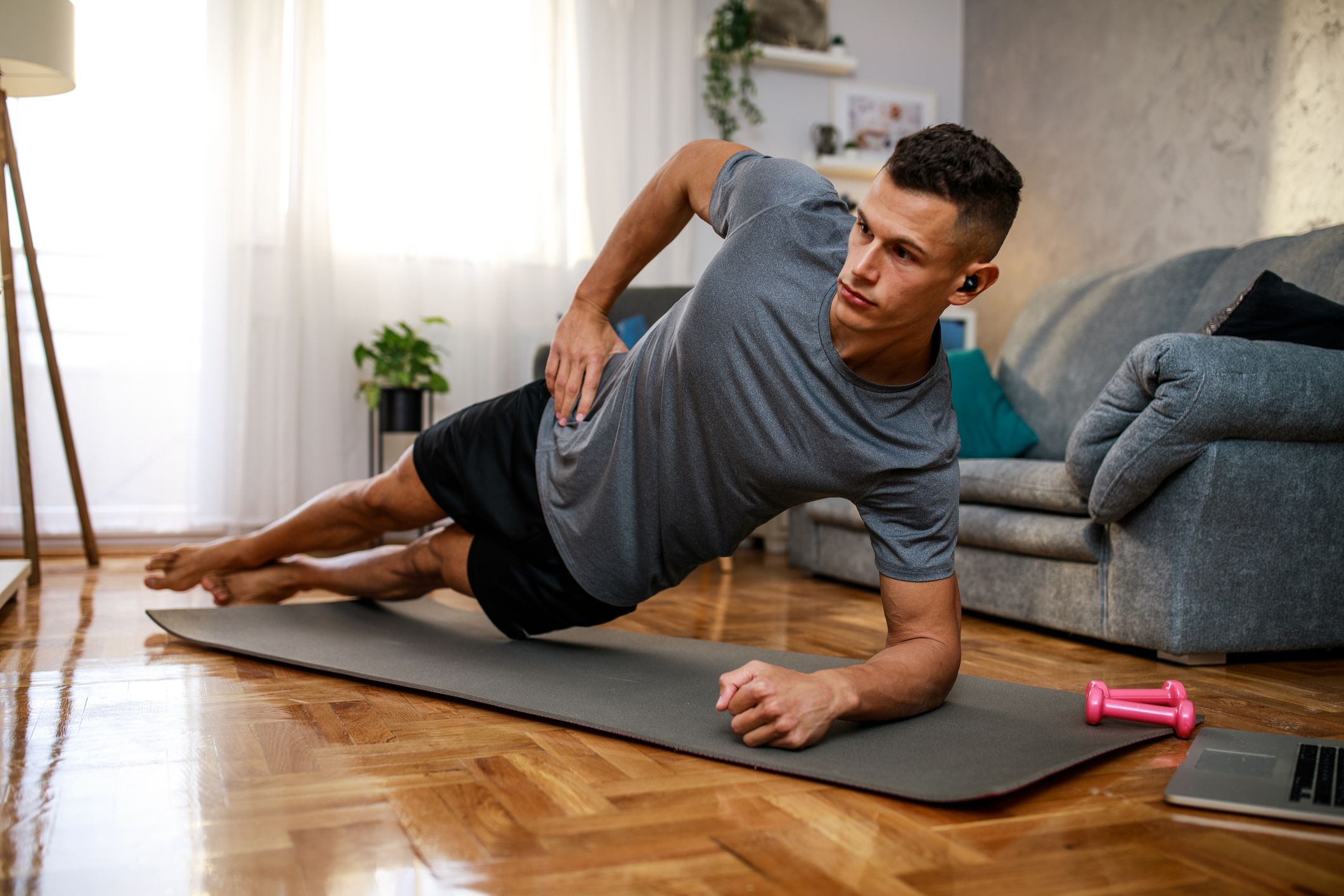 Yoga mat woman stretching hip, hamstring muscles and groin area