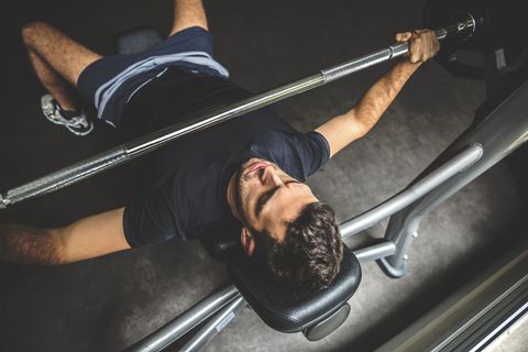 Young man doing bench press exercise
