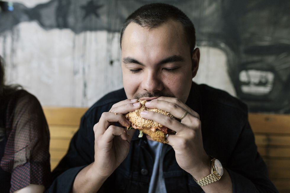young man eating a burger