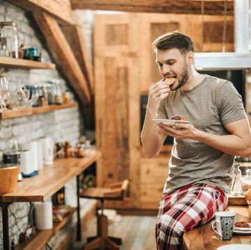 young man eating breakfast in the morning.