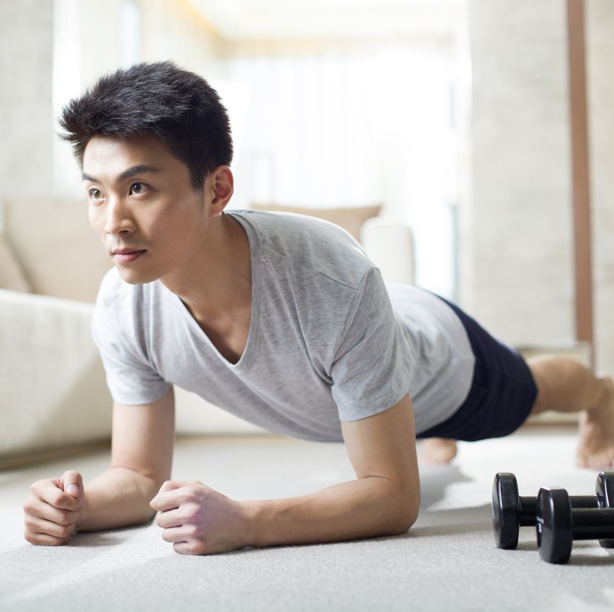 young man exercising at home
