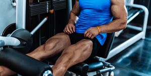 Young man exercising legs in the local gym