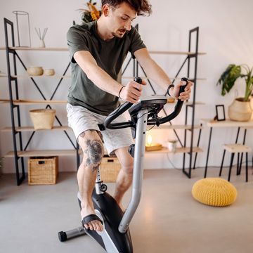 young man exercising on a stationary bike