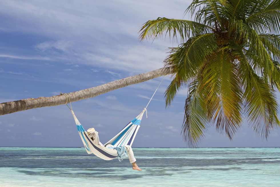 young man in hammock contemplating the sea