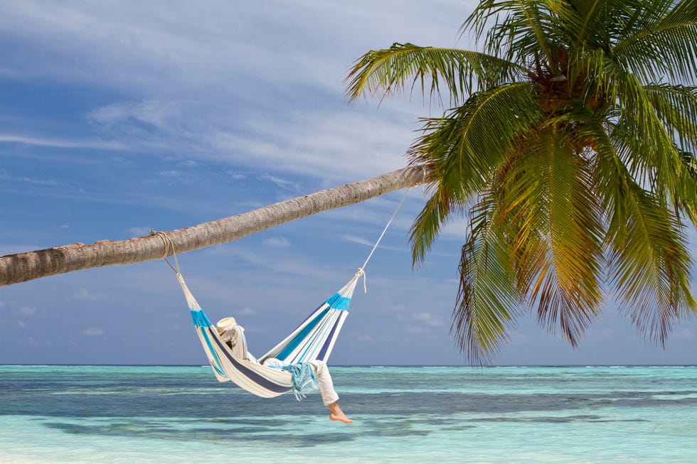 young man in hammock contemplating the sea