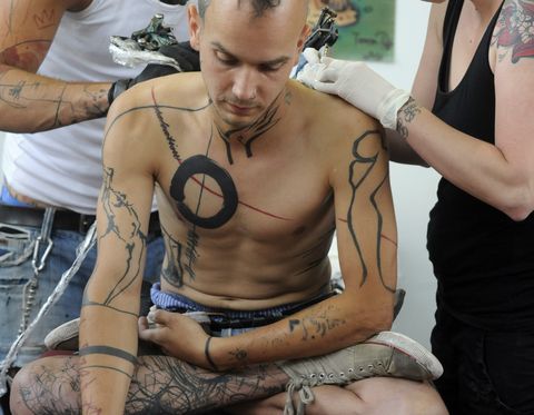 a young man is tattooed during the 13th