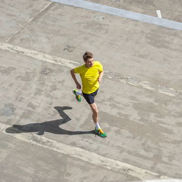 young man jogging, concrete floor