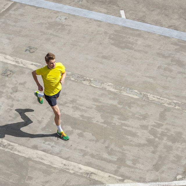 young man jogging, concrete floor