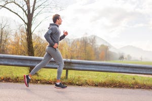 young man jogging on autumn day