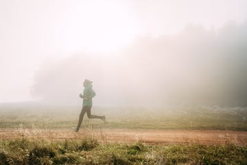 morning run  young man jogging on cold foggy morning