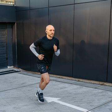 young man jogging outdoors in the parking lot