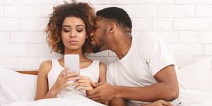 young man molesting his offended wife networking on cellphone
