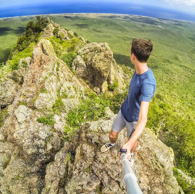 Young Man On The Top Of A Dangerous Cliff