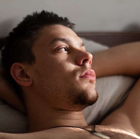 young man relaxing in bed