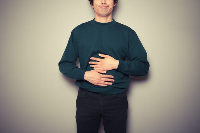 https://hips.hearstapps.com/hmg-prod/images/young-man-rubbing-his-stomach-royalty-free-image-1646165987.jpg?crop=0.66661xw:1xh;center,top&resize=640:*