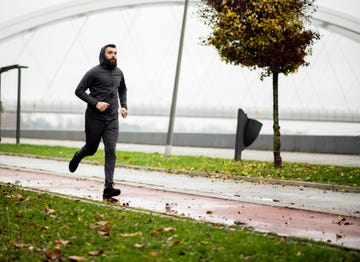 young man running by the river