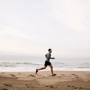 Young man running on the beach young man running on the beach