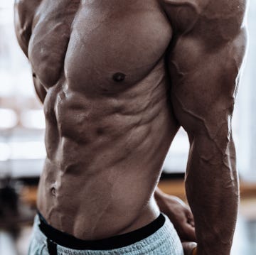 young man showing his muscles in the gym