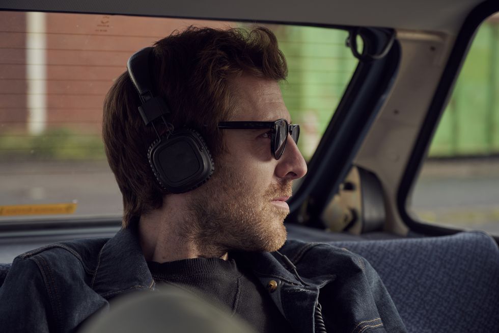 man listening to headphones in a car
