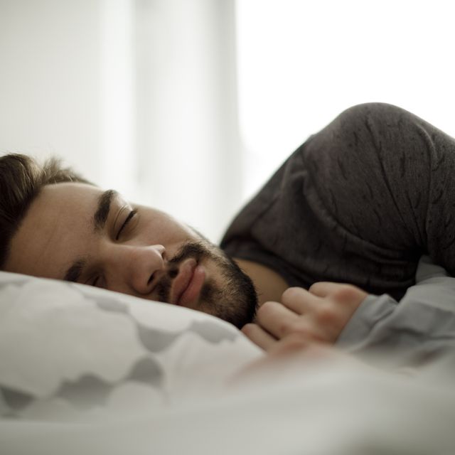 https://hips.hearstapps.com/hmg-prod/images/young-man-sleeping-in-bed-at-home-royalty-free-image-1635618352.jpg?crop=0.667xw:1.00xh;0.124xw,0&resize=640:*