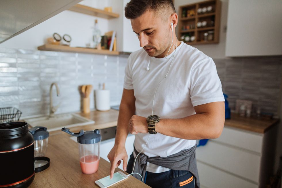 young man synching smartphone app with smart wear device