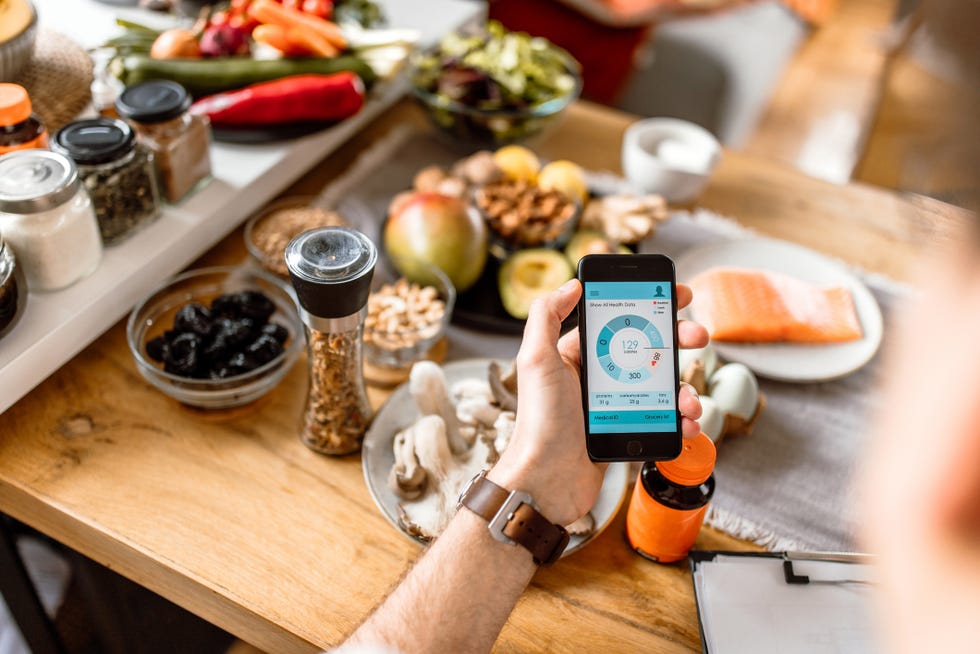 young man tracking food intake with mobile app at home