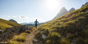 young man trail running on the dolomites mountain
