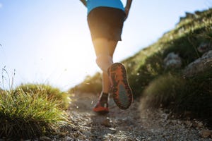 young man trail running on the mountain