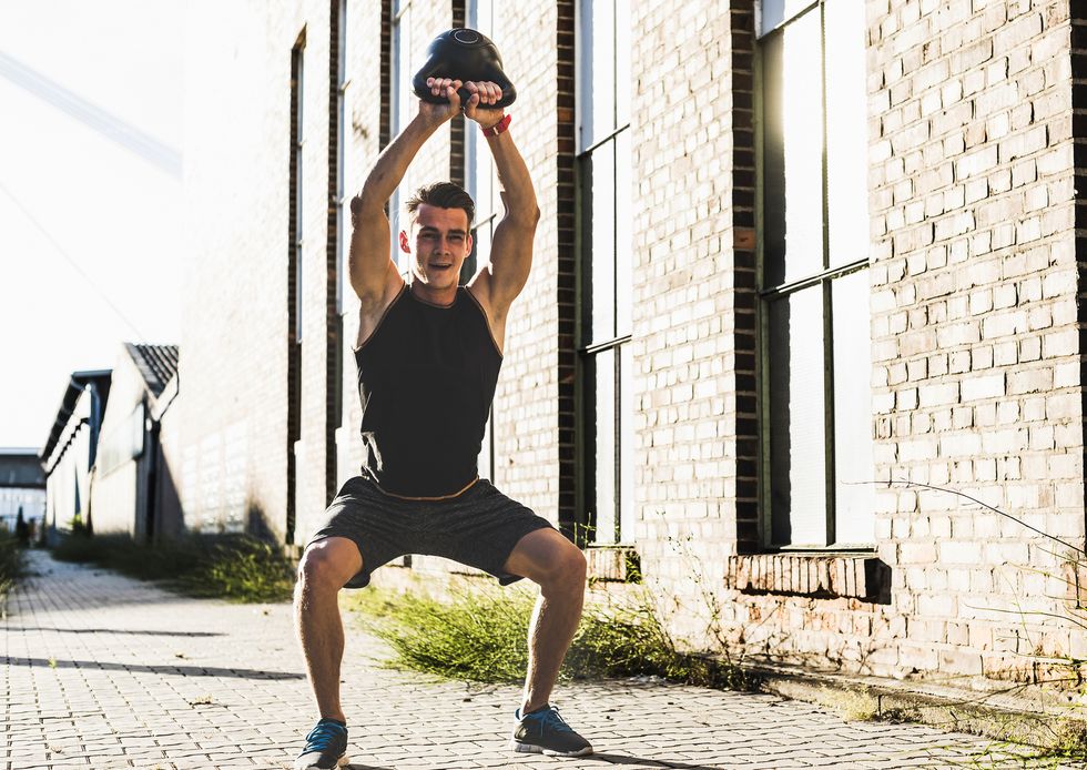 Young man training with a kettle bell