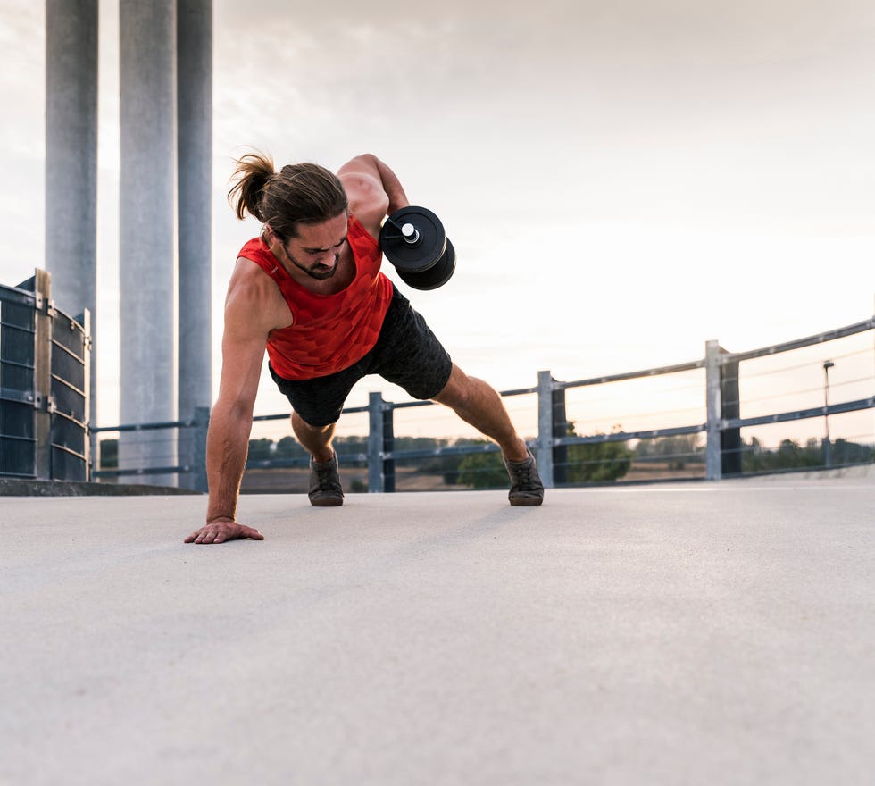 young man training with dumbbells