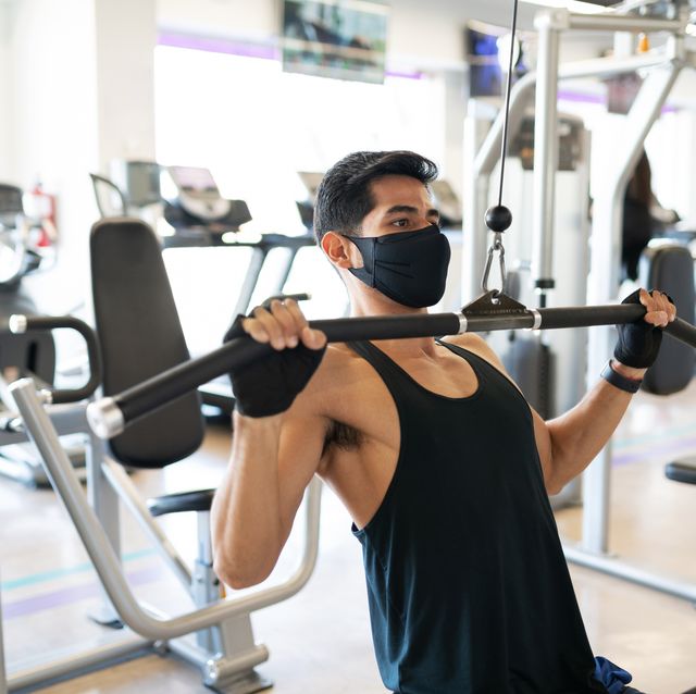 https://hips.hearstapps.com/hmg-prod/images/young-man-with-a-mask-exercising-in-the-cable-royalty-free-image-1617964612.?crop=0.669xw:1.00xh;0.210xw,0&resize=640:*