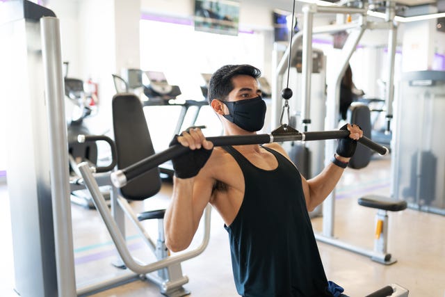 https://hips.hearstapps.com/hmg-prod/images/young-man-with-a-mask-exercising-in-the-cable-royalty-free-image-1617964612.?crop=0.669xw:1.00xh;0.210xw,0&resize=640:*