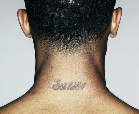 young man with tattoo on neck, close up, rear view