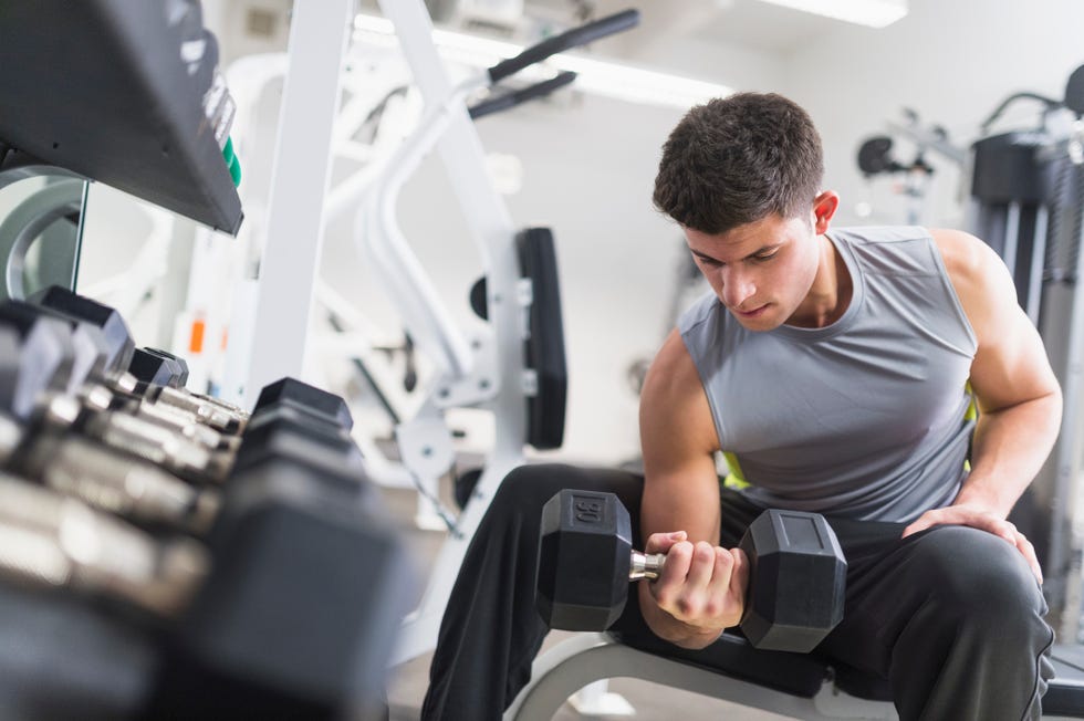 young man working out at gym, jersey city, new jersey, usa