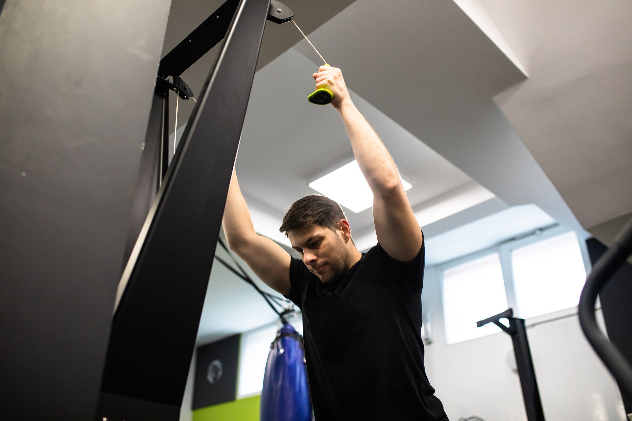 a young man working out on a skierg machine