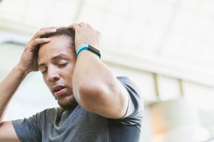 young mixed race man wearing fitness tracker