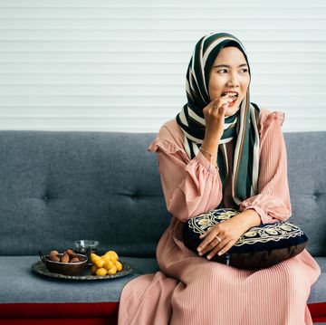 young muslim woman eating date