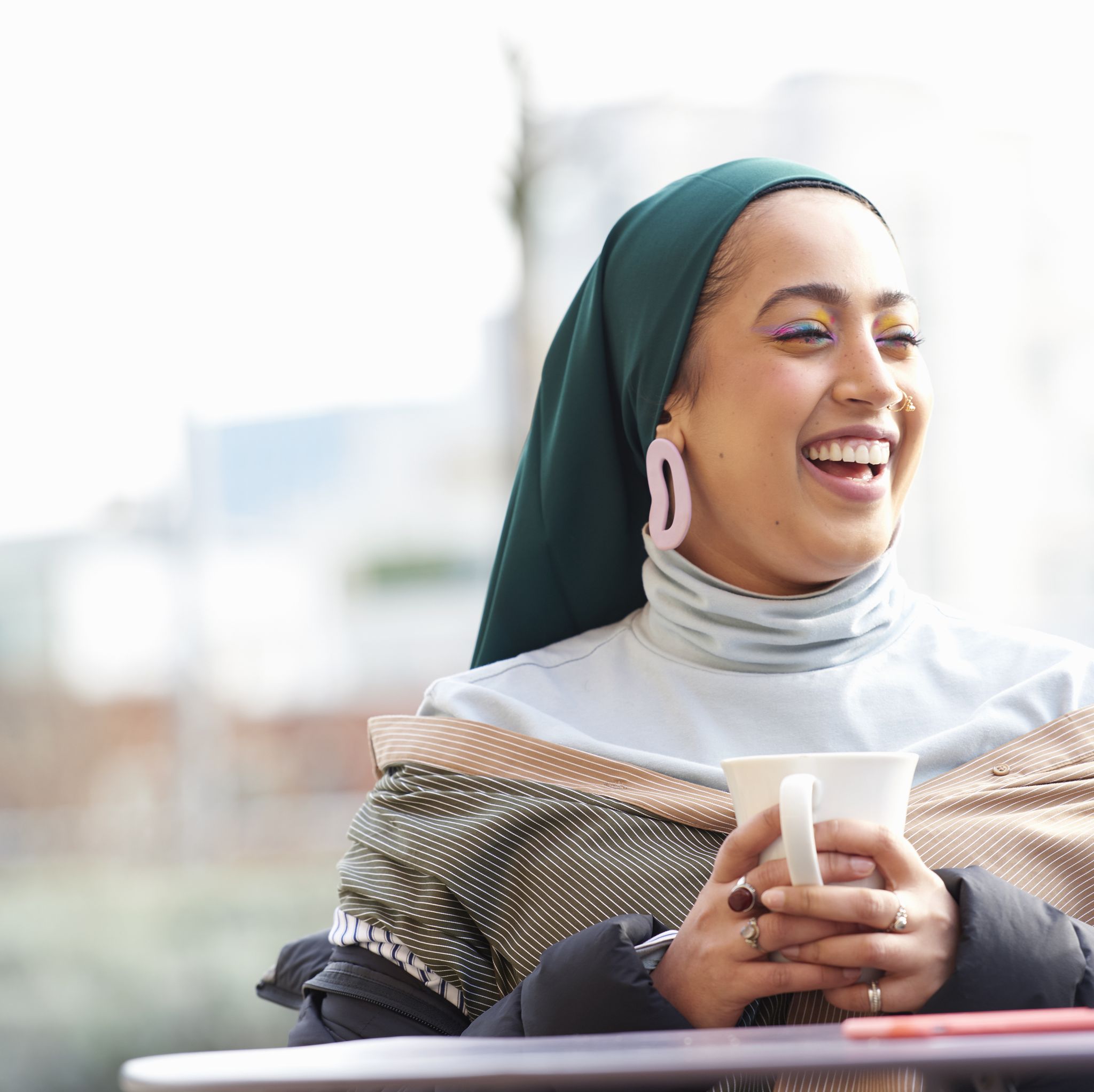 Young muslim woman laughing.