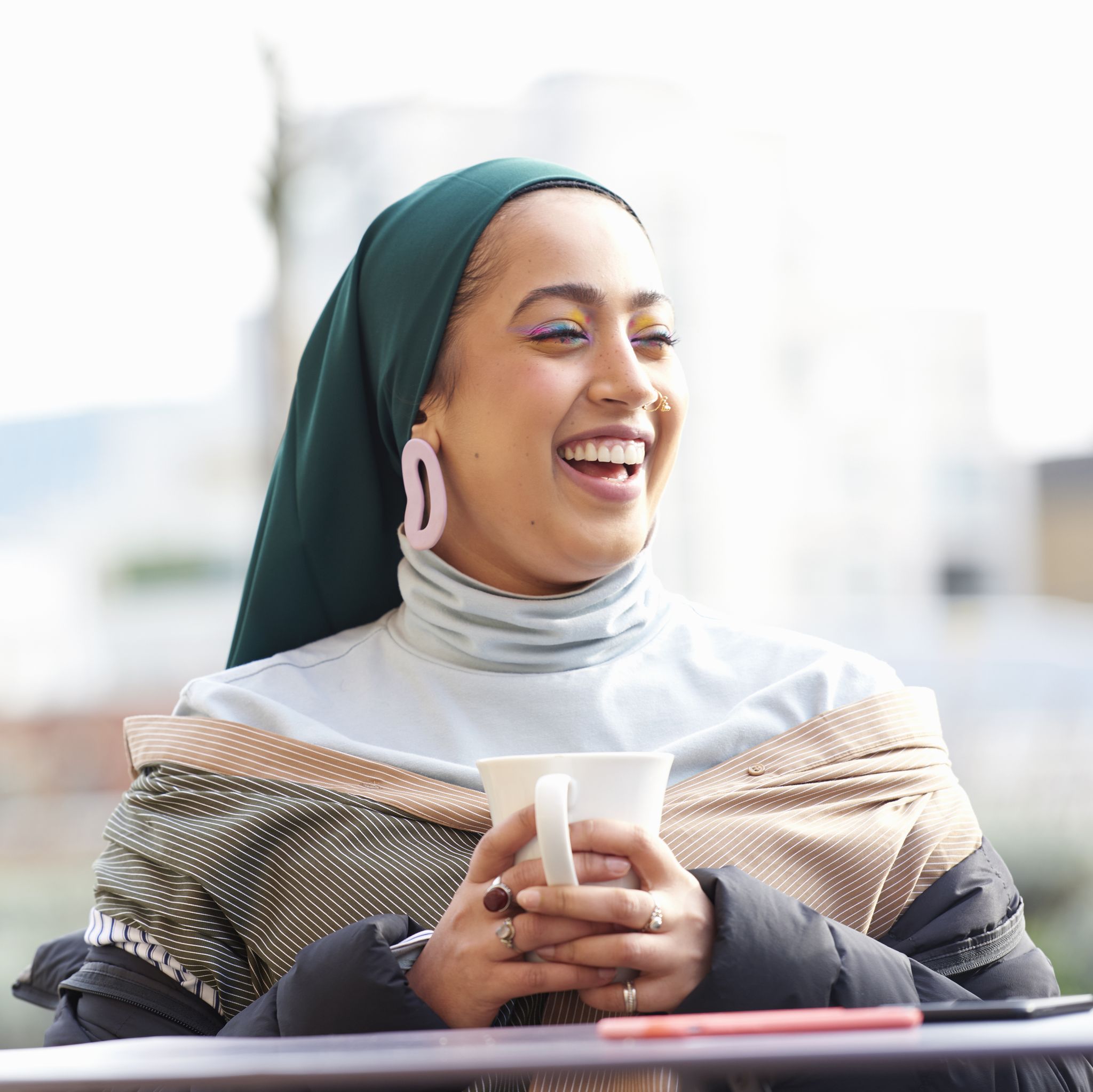 Young muslim woman laughing.