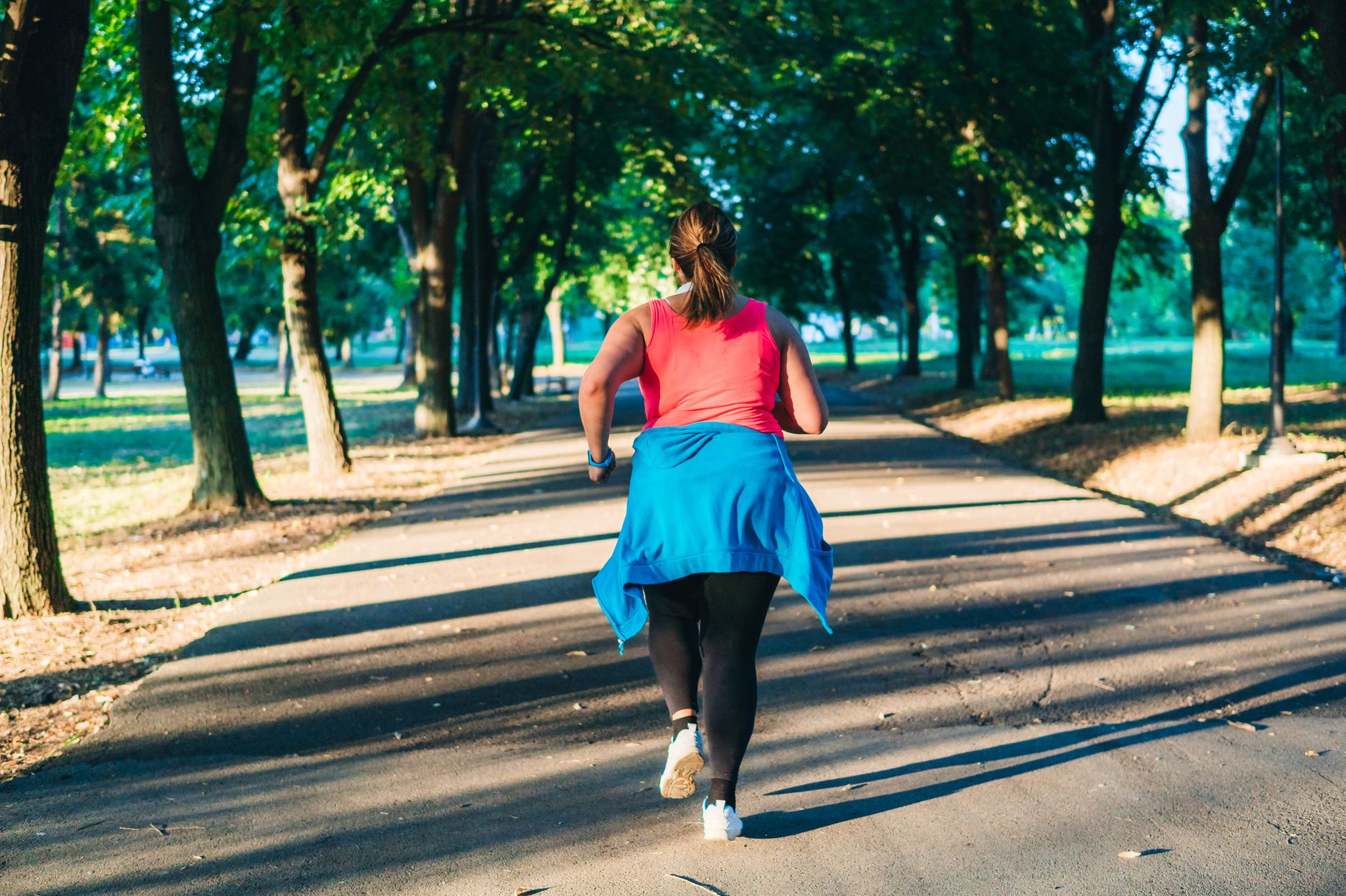 young overweight woman running