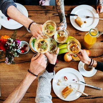 Young people having a toast with a glass of wine.