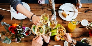 Young people having a toast with a glass of wine.