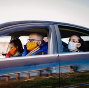 covid 19, young people wearing disposable face mask while driving