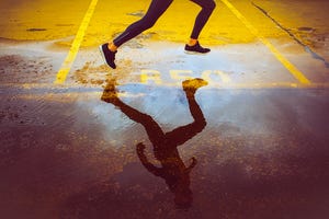 young person running over the parking lot